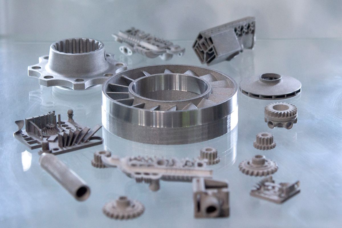 Metal parts made on a 3D printer from metal powder, laid out on a glass surface