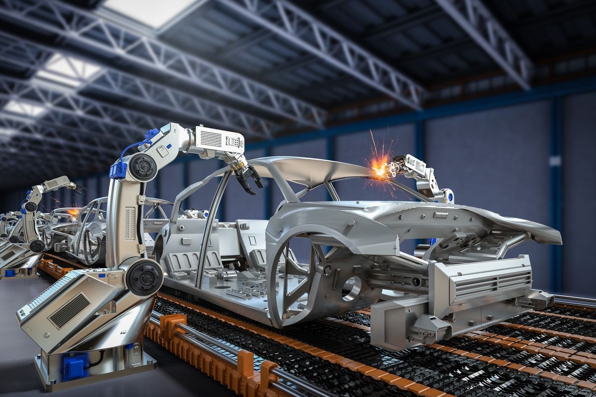 Robotic arms welding vehicle bodies on an automated production line